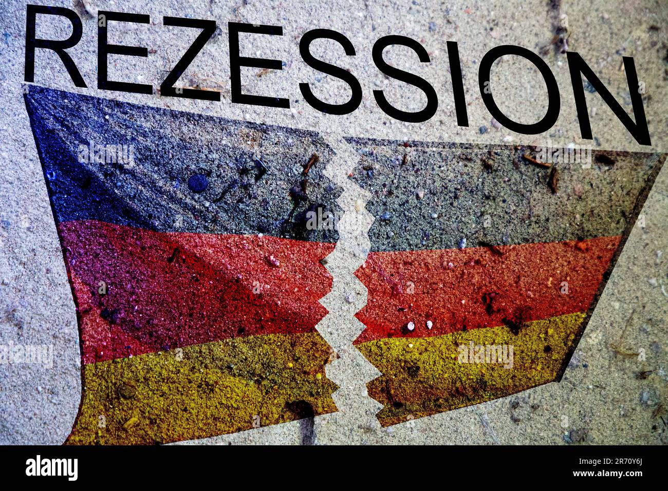 Symbol image of recession in Germany: Torn German flag on a stone background, with the word recession written above it Stock Photo