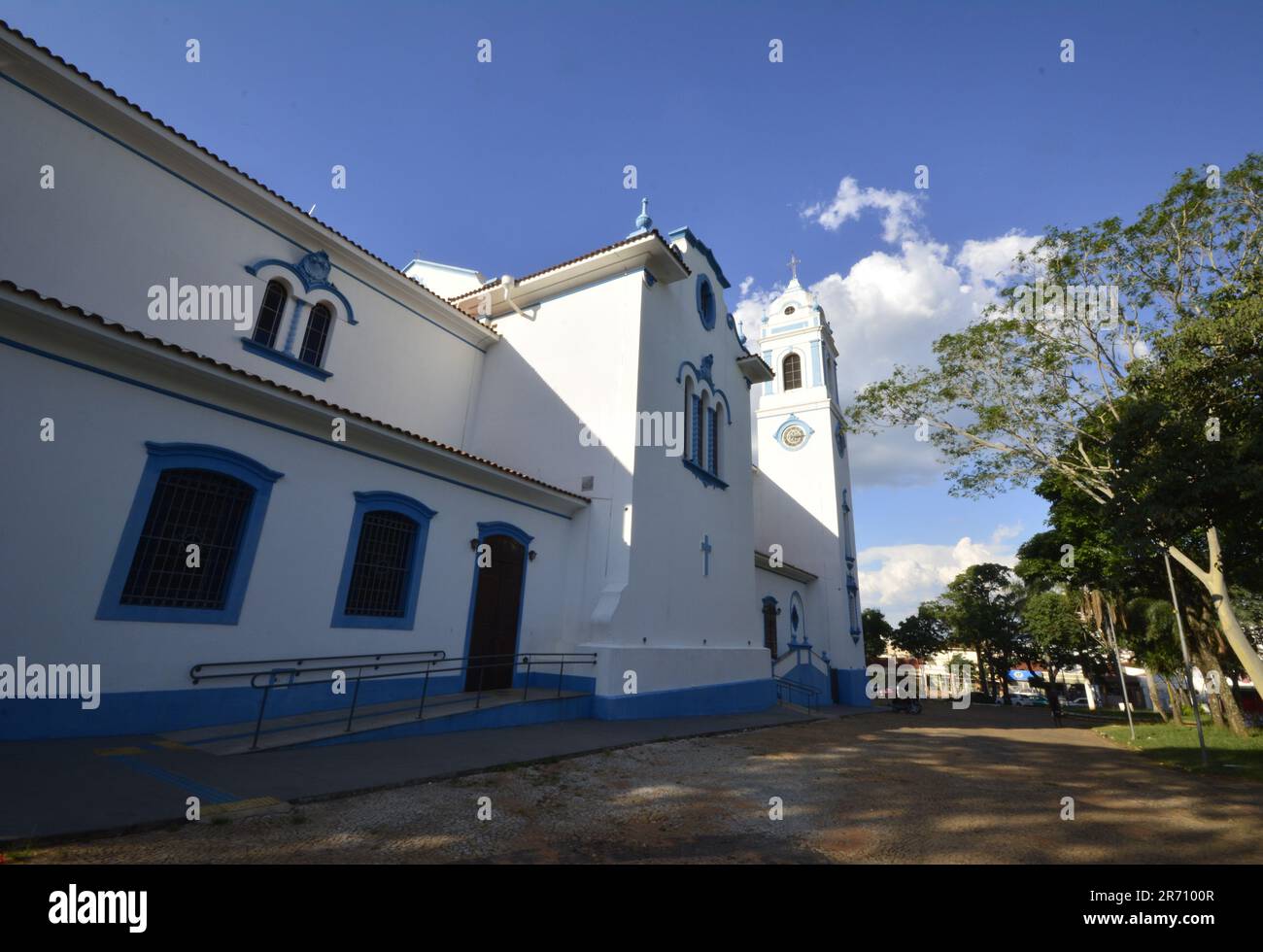 ide view of Catholic Church in Brazil with blue sky with clouds and nature on the side. wide angle photo Stock Photo