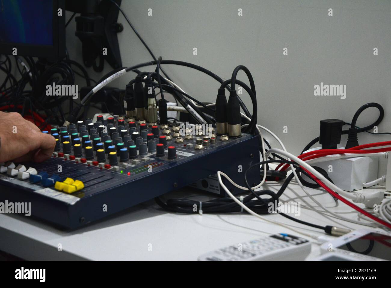 Sound table with the sound technician's hand adjusting the control buttons, Brazil, South America in zoom photo, with side view Stock Photo