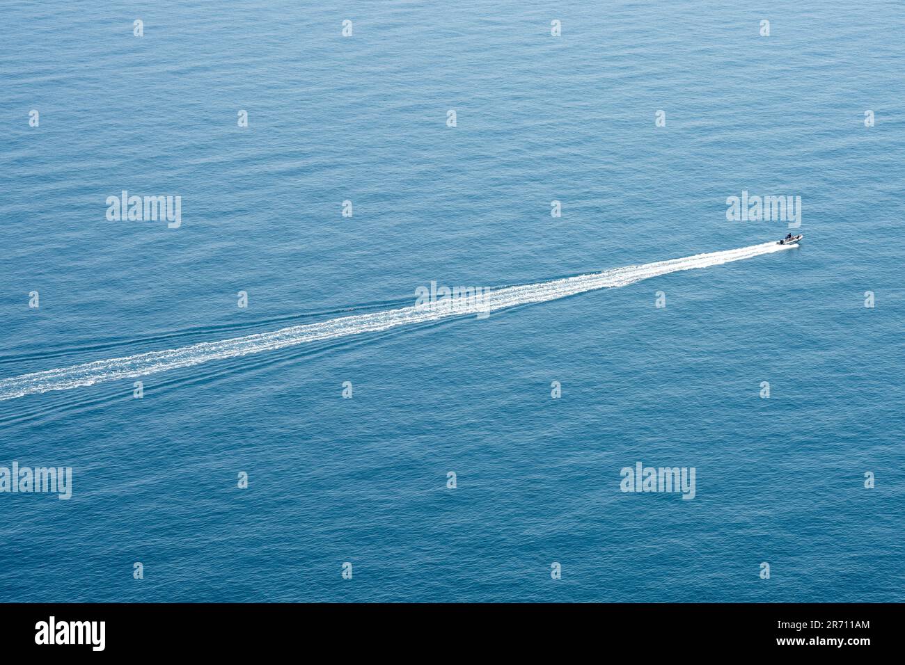 fast boat skims over the blue water Stock Photo