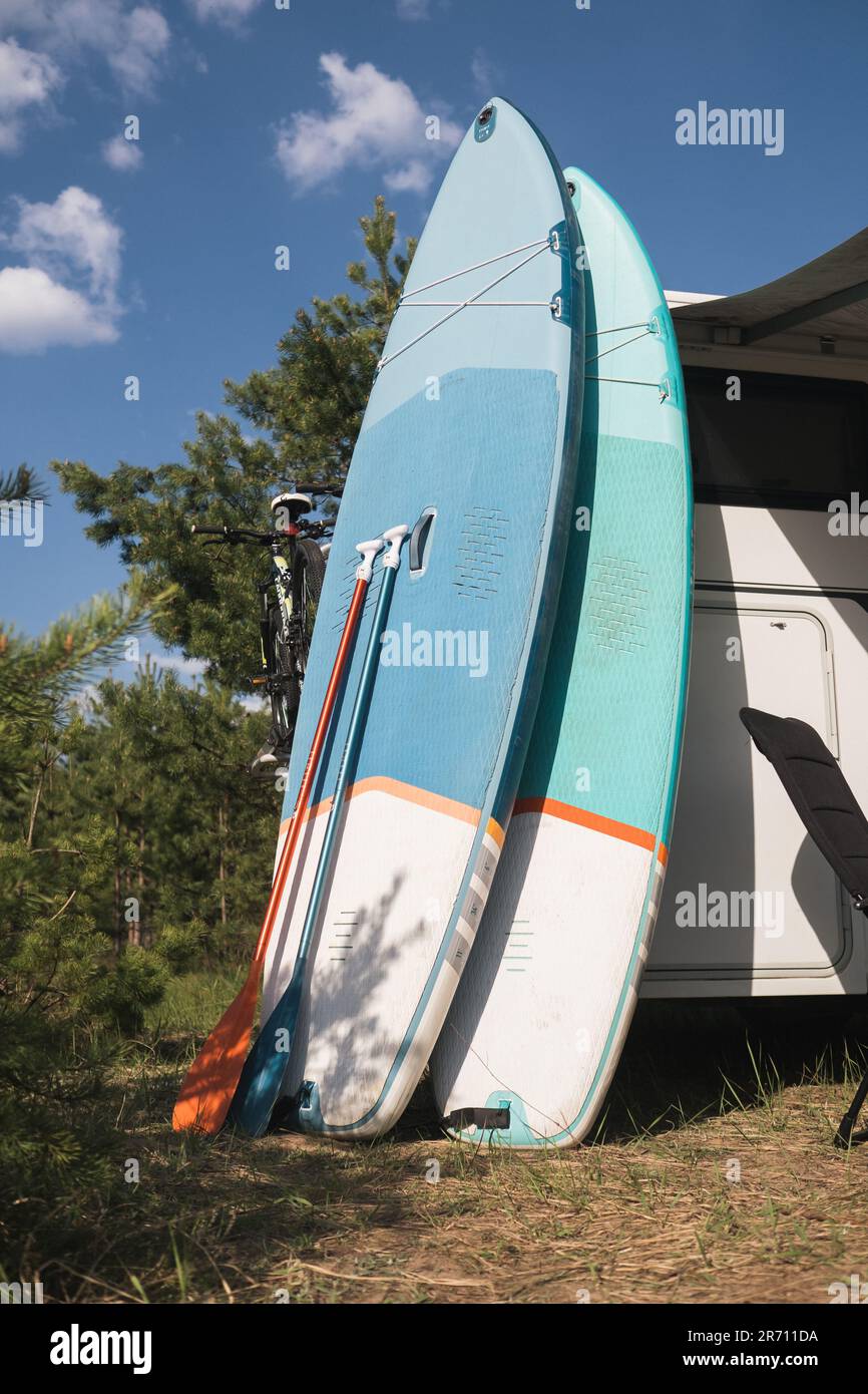 Inflatable Sup rowing boards stand near the motorhome inflated in