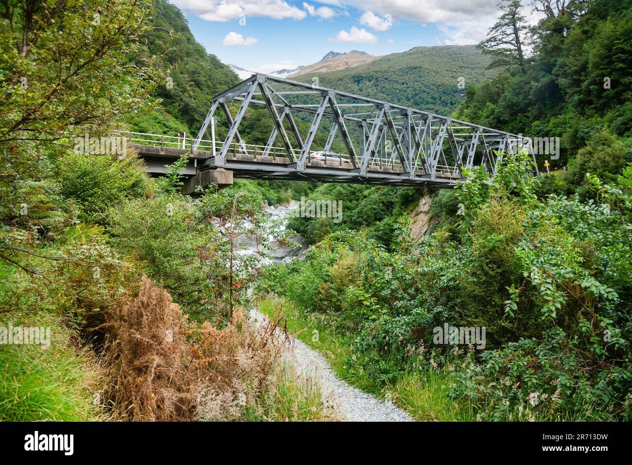 Single lane Callender-Hamilton steel truss bridge over the Haast River at Gates of Haast gorge in Mount Aspiring National Park, South Island of New Ze Stock Photo