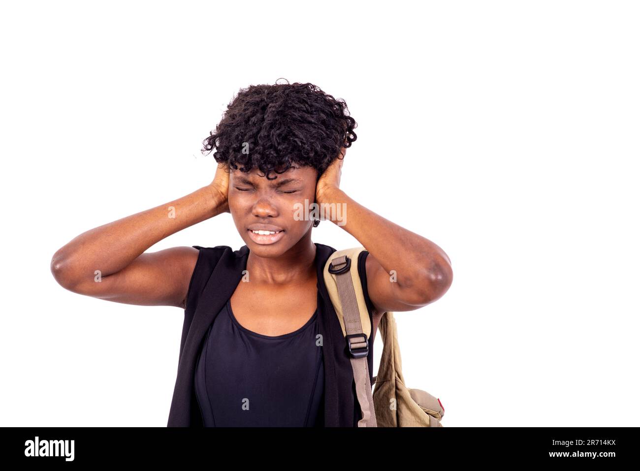 young student with backpack standing on white background covering her ...