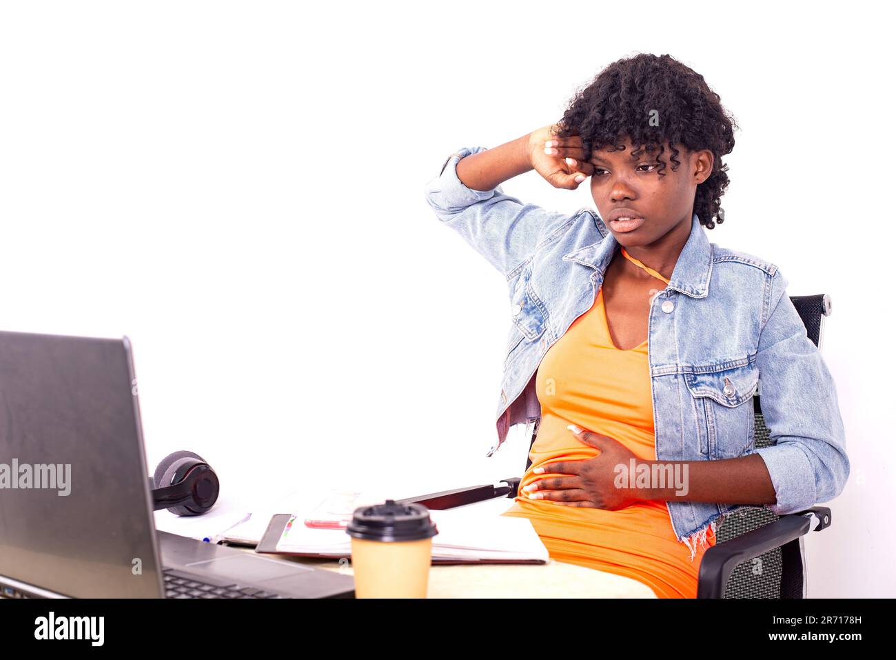 young sick student girl sitting in front of laptop suffering from