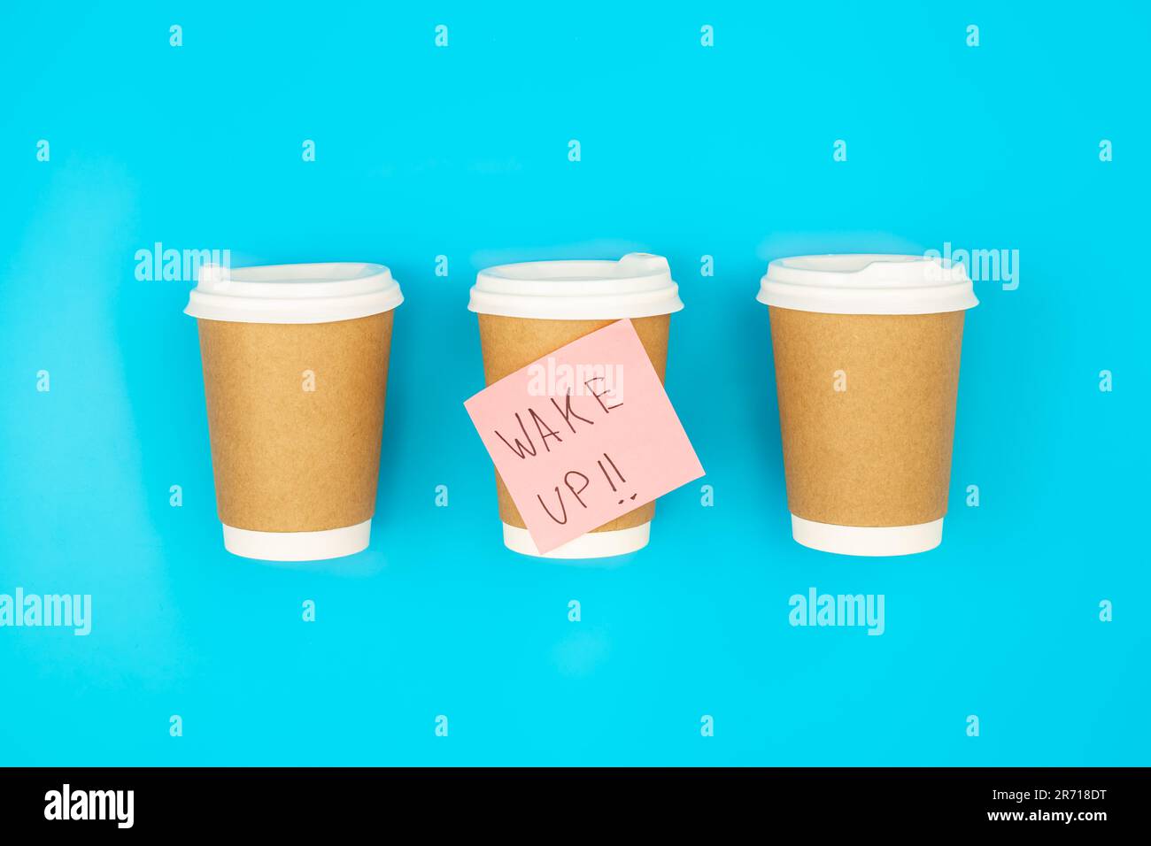 Paper disposable cups and paper reminder with text Wake up Stock Photo ...