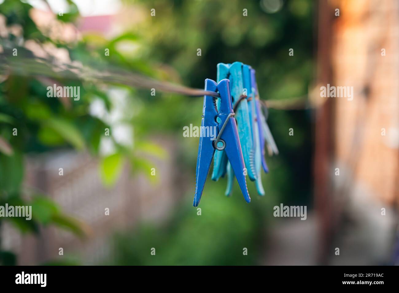 Multi-colored clothespins on a clothesline close up. Stock Photo