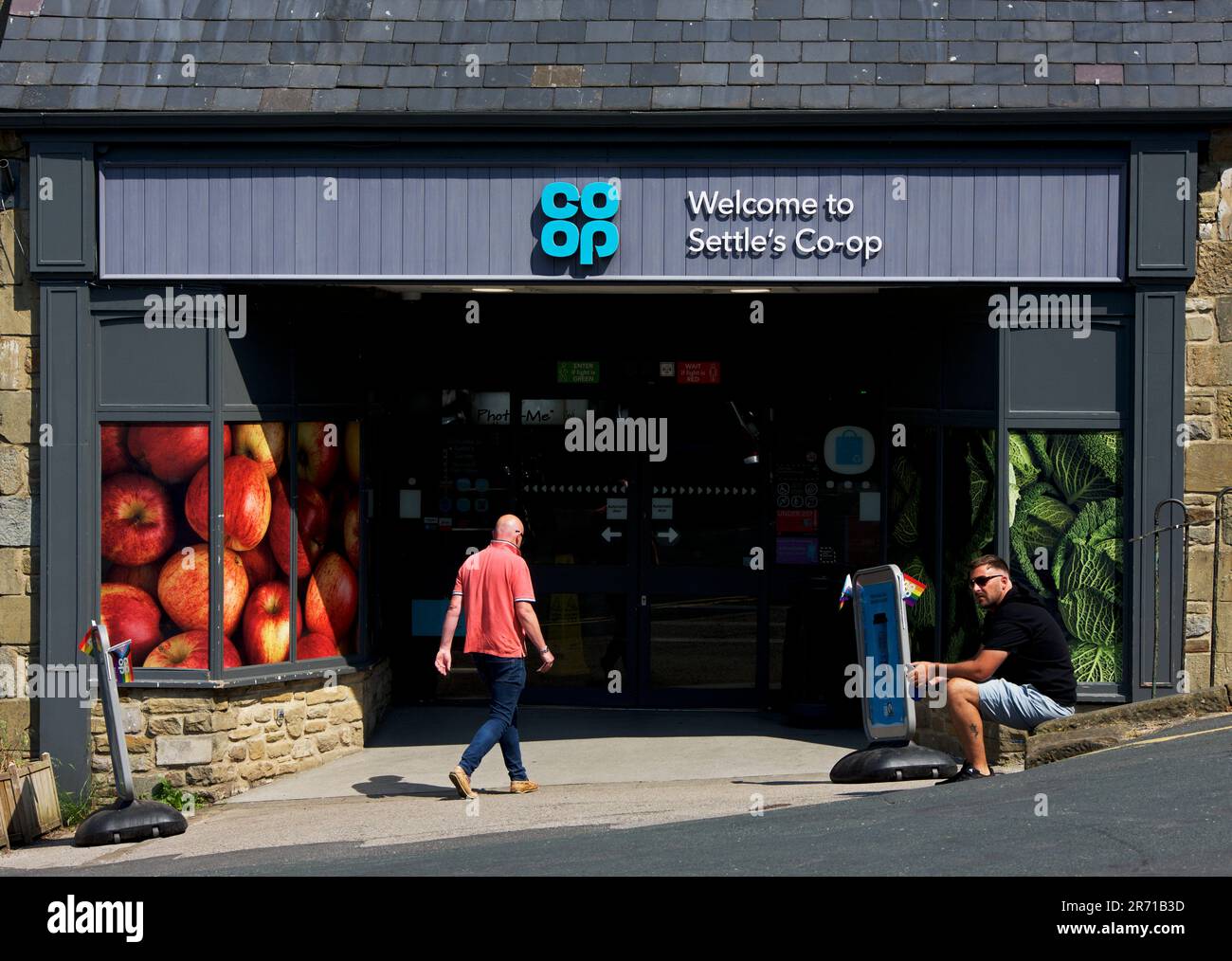 Man walking into Coop store, Settle, North Yorkshire, England UK Stock