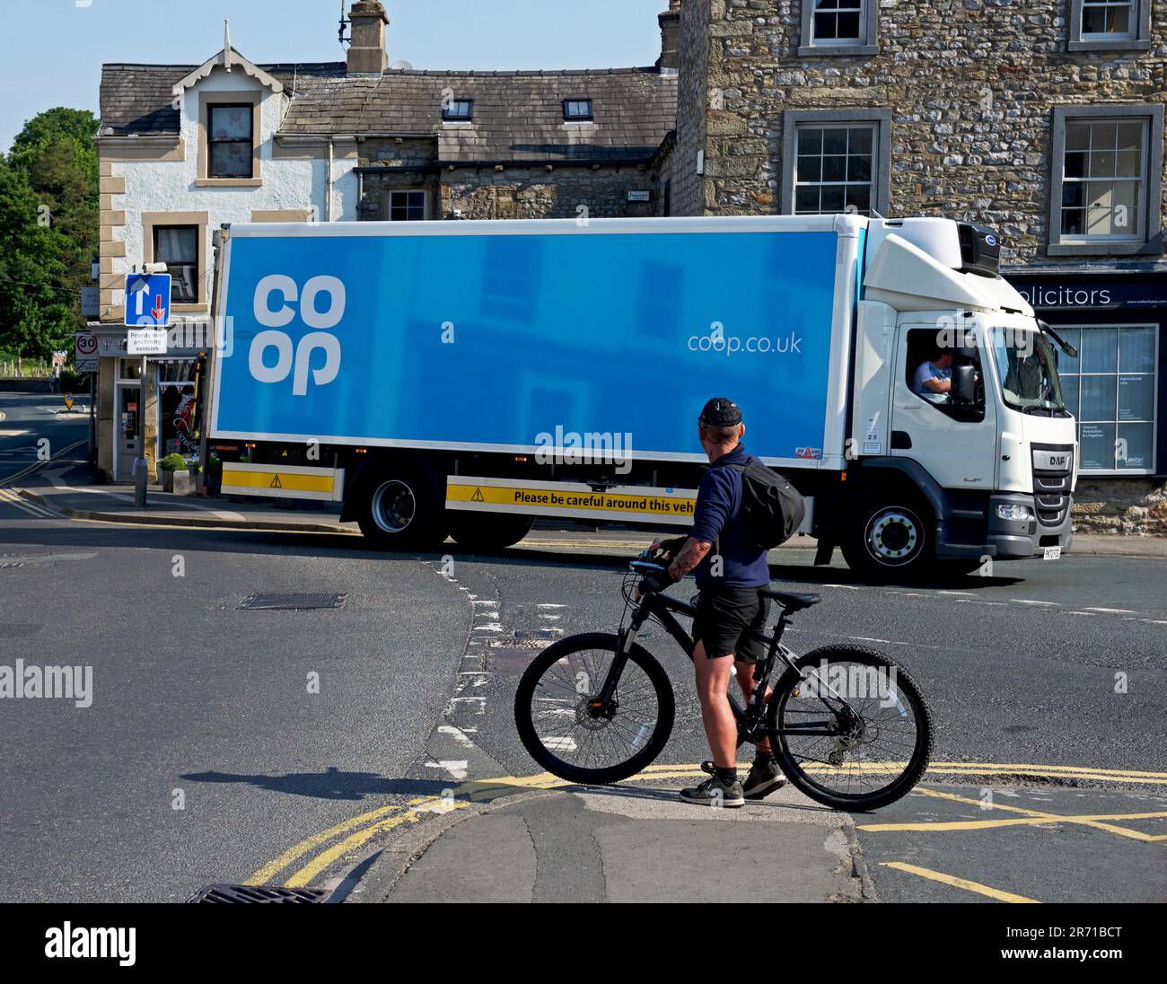 Coop delivery van squeezing into loading bay of Coop store, in Settle, North Yorkshire, England UK Stock Photo