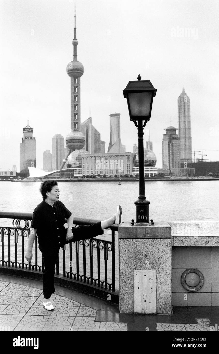 Shanghai China 2000. Morning exercises on the Bund. The distinctive  balconettes overlooking the Huangpu are part of the new Bund embankment  which was completed between 1991 and 1993. The Bund was enlarged
