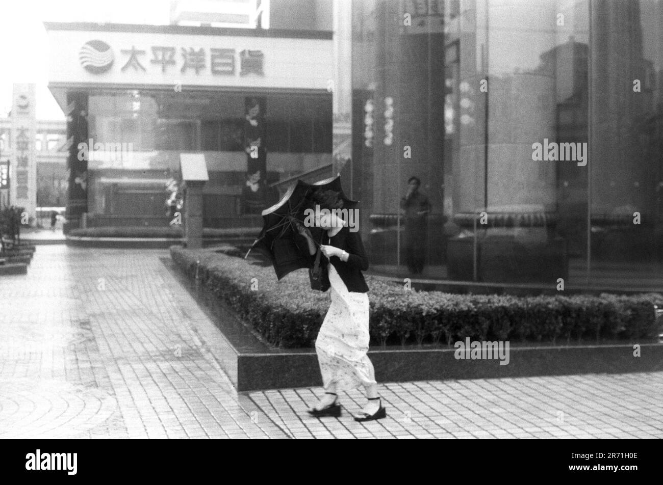 Shanghai China 2000. Typhoon!  Heavy rain and the occasional typhoons occur during the summer months of June to August when it is very hot and humid. Due to climatic change and Shanghai?s sheltered position typhoons are now quite minimal and not as destructive as those experienced by Hong Kong or Taiwan.  September and October are considered the best months in Shanghai, while winters are similar to those in southern England, which may seem surprising given that the city is on the same latitude as Cairo. 2000s HOMER SYKES Stock Photo