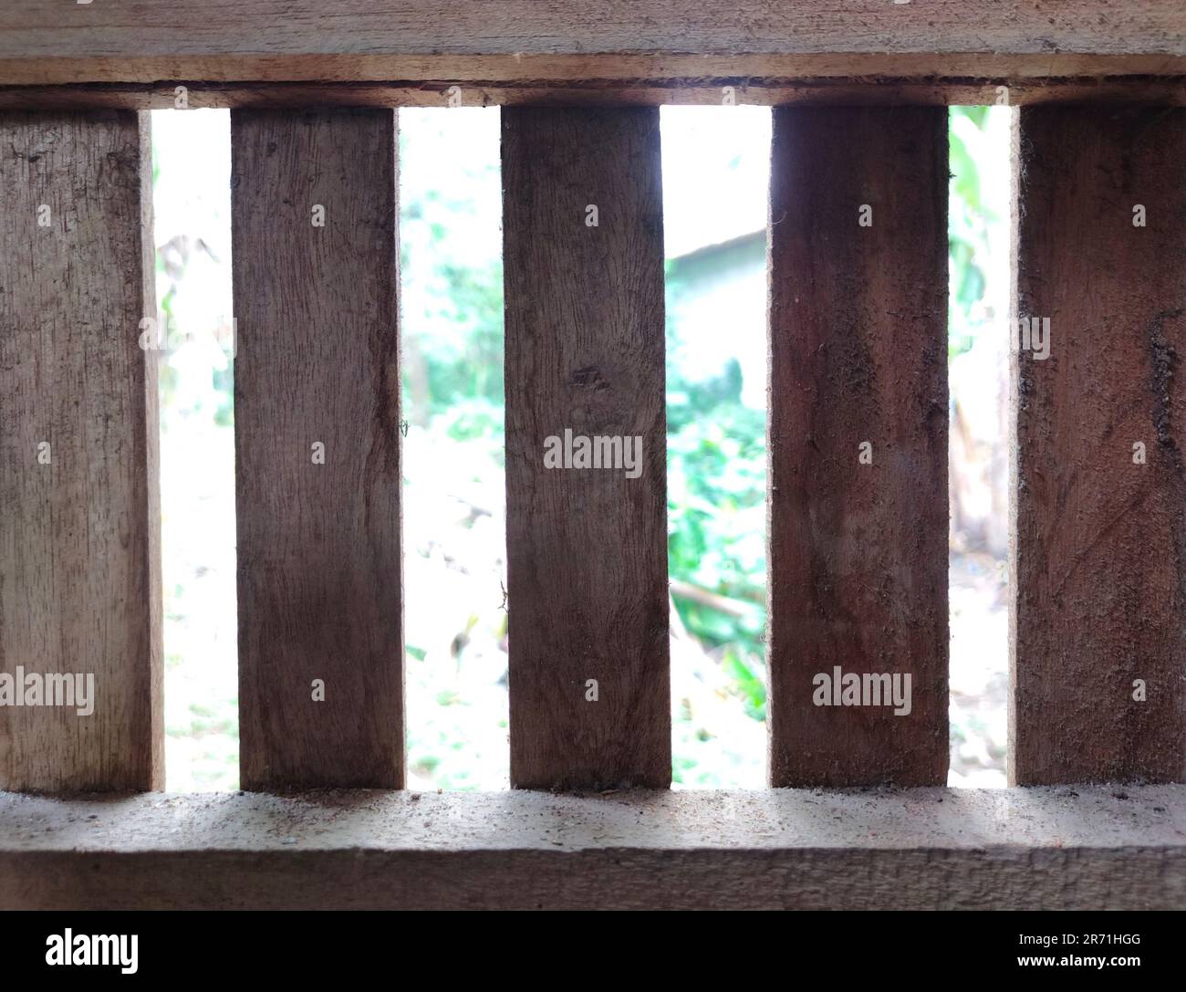 A traditional wooden air vent in my grandma's kitchen. Against a garden background Stock Photo