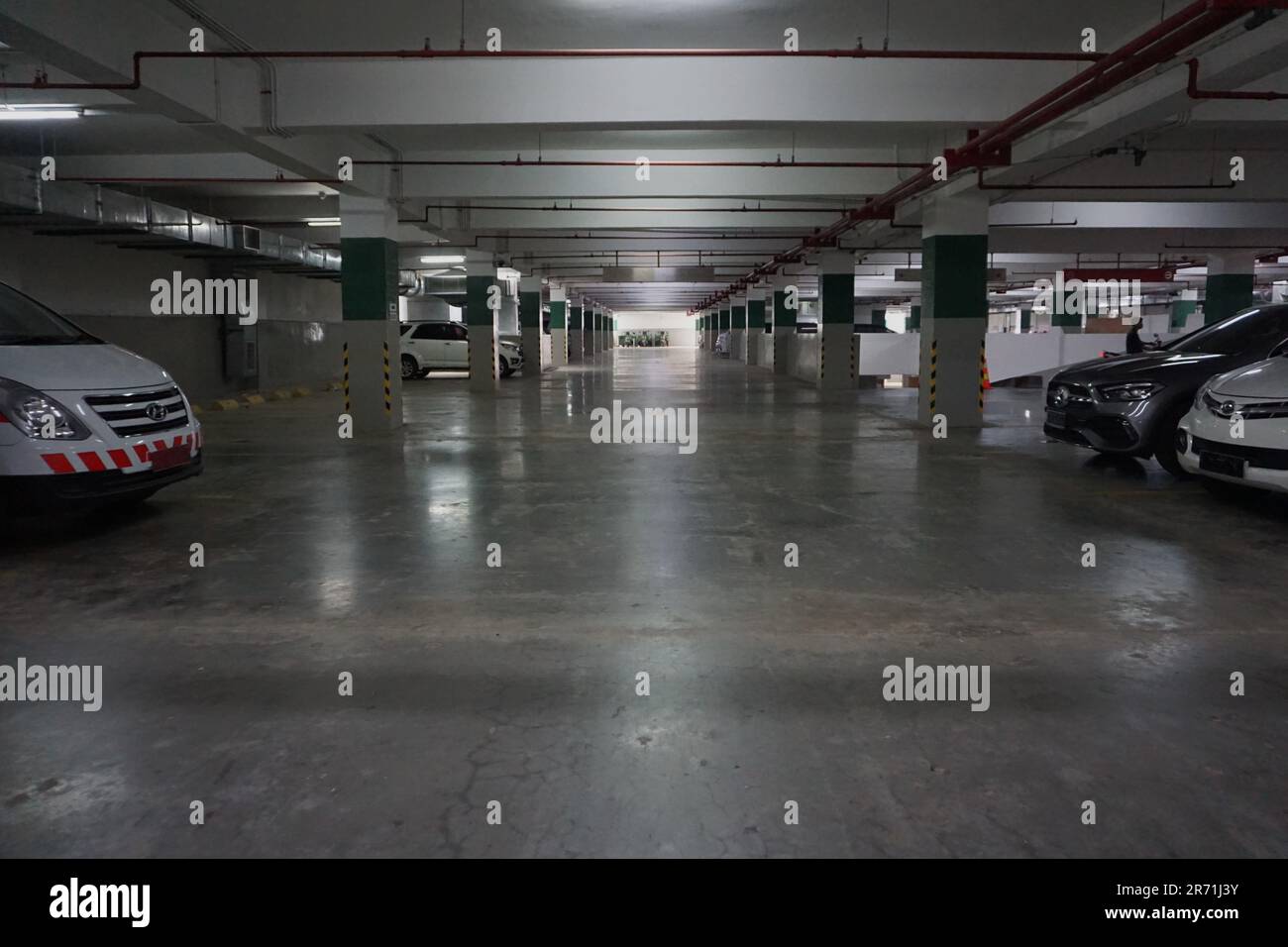 Photo of car and motorbike parking in the basement of a building ...