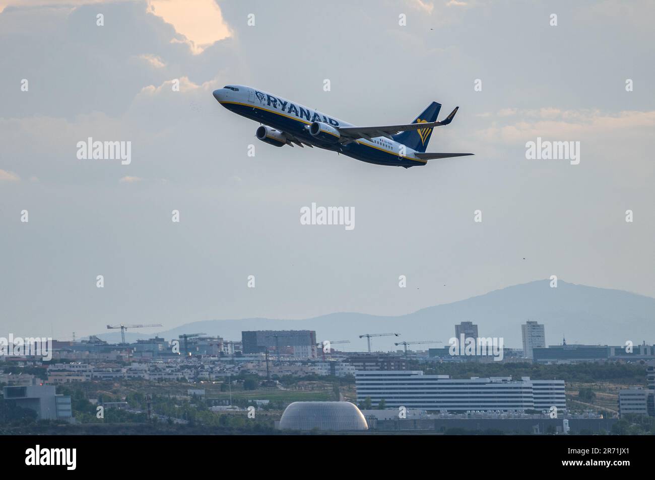A Boeing 737 of Ryanair comercial flight flying after departing from Adolfo Suarez Madrid Barajas Airport. Stock Photo