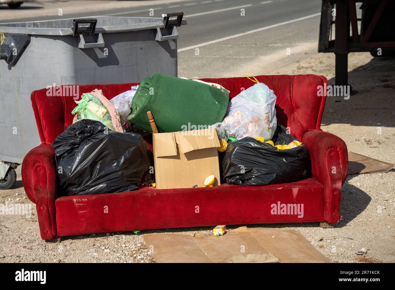 Sofa full of garbage bags and boxes Stock Photo