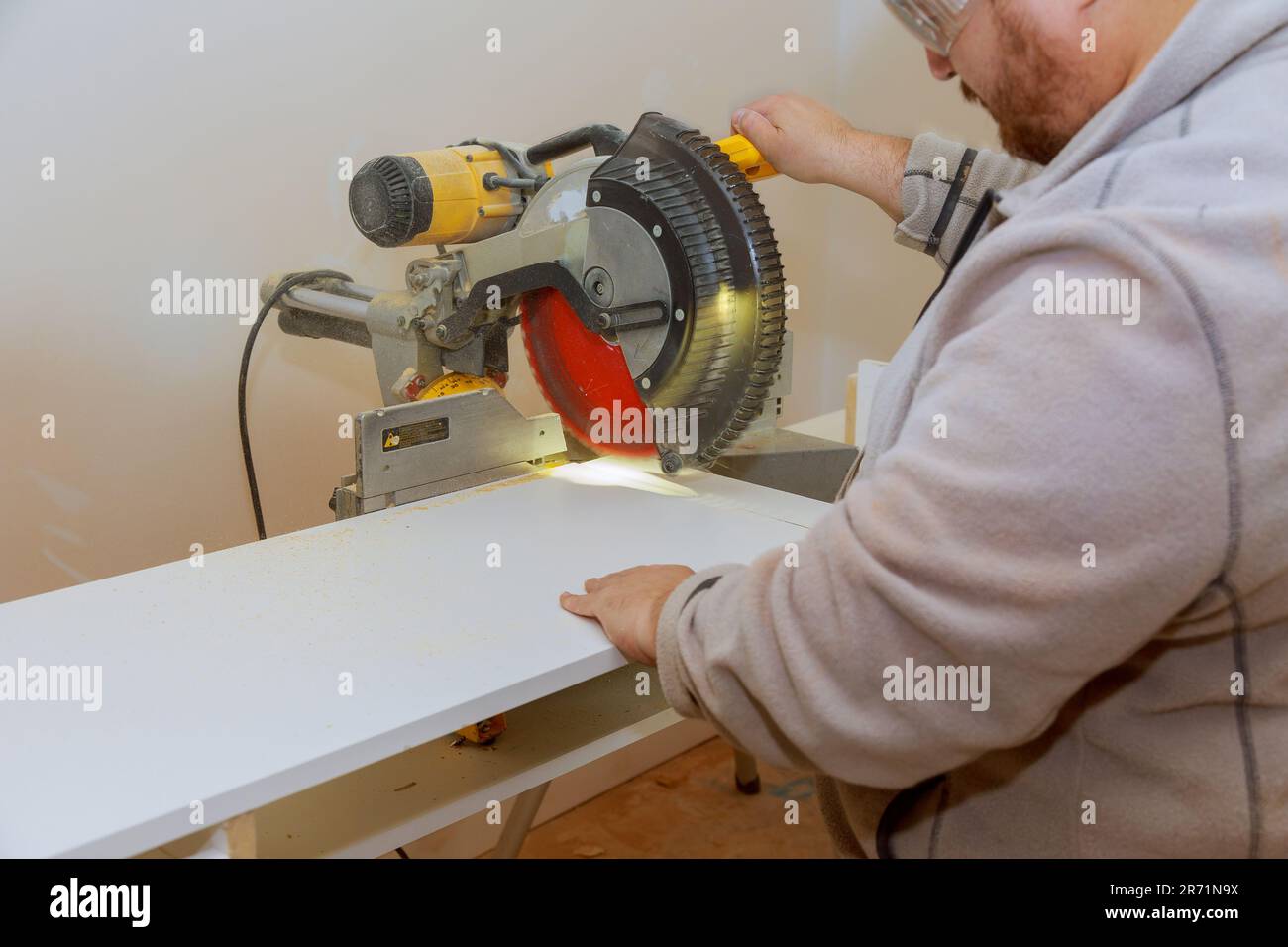 Circular saw is used by worker to cut melamine board for shelves heavy