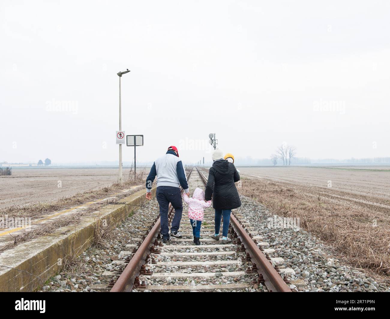 Family walking on track. immigrants. italy Stock Photo