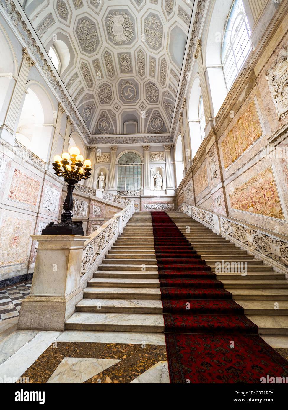 Rose marble walls of the great staircase designed by the architect Gaetano Genovese in 1837 in the Royal Palace of Naples that In 1734 became the royal residence of the Bourbons - Naples, Italy Stock Photo