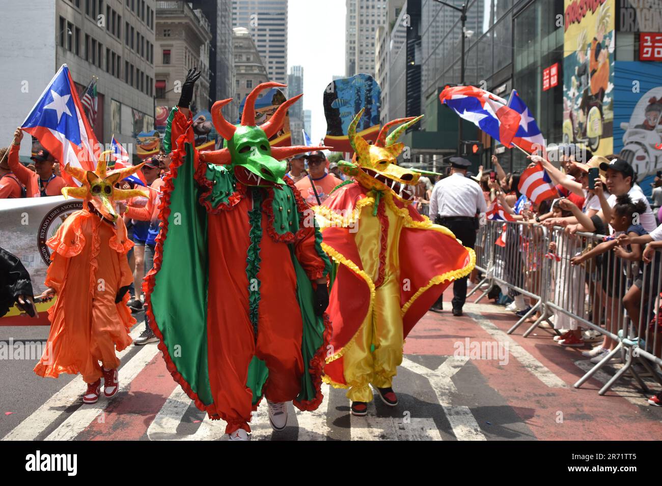 Marchers in Vejigantes mask costumes of Puerto Rico walking in the parade. Stock Photo