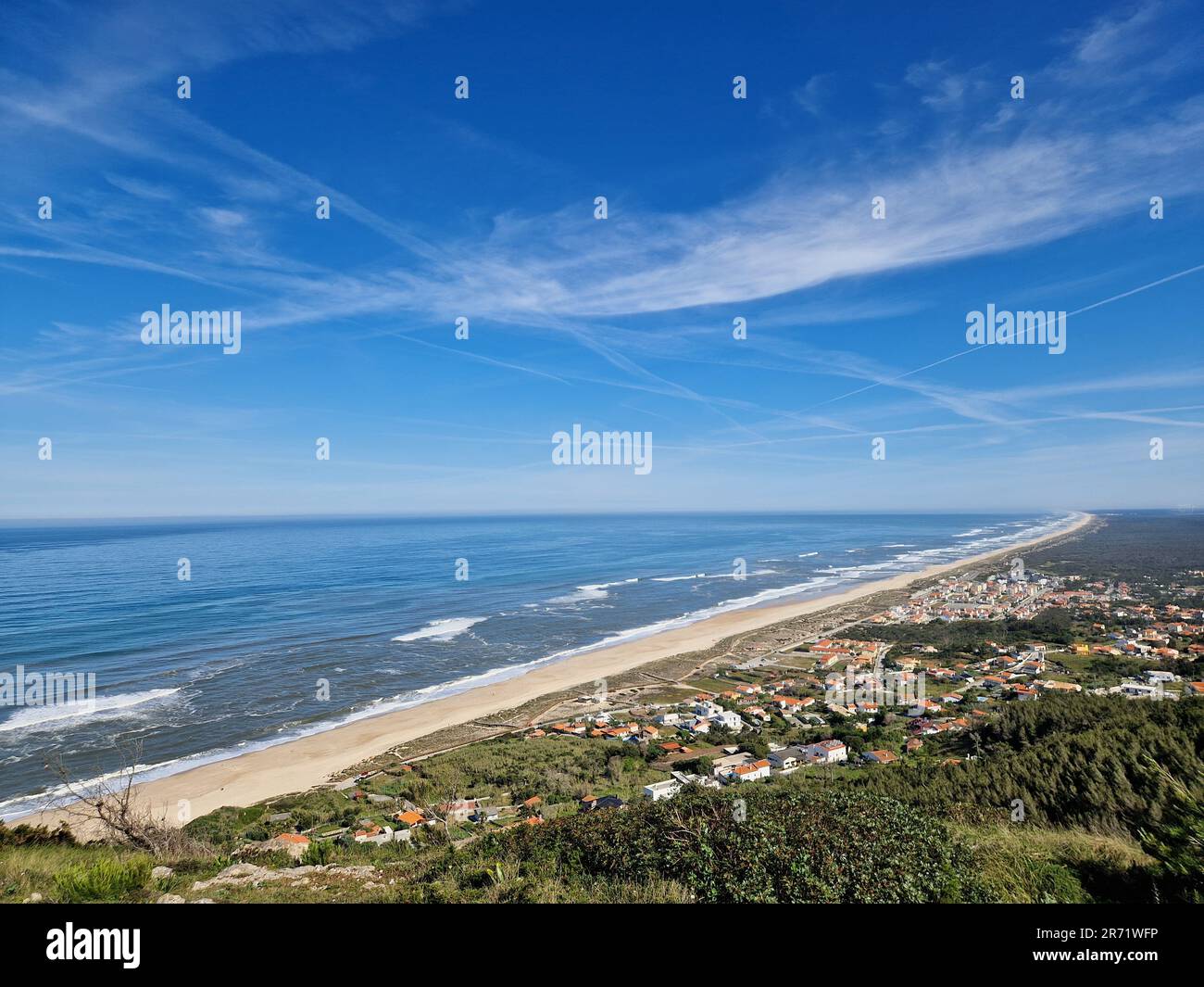 View from the top of mountain over Murtinheira, Quiaios Beach and residential area. View over the vast blue Atlantic ocean, blue sky and neighborhood Stock Photo