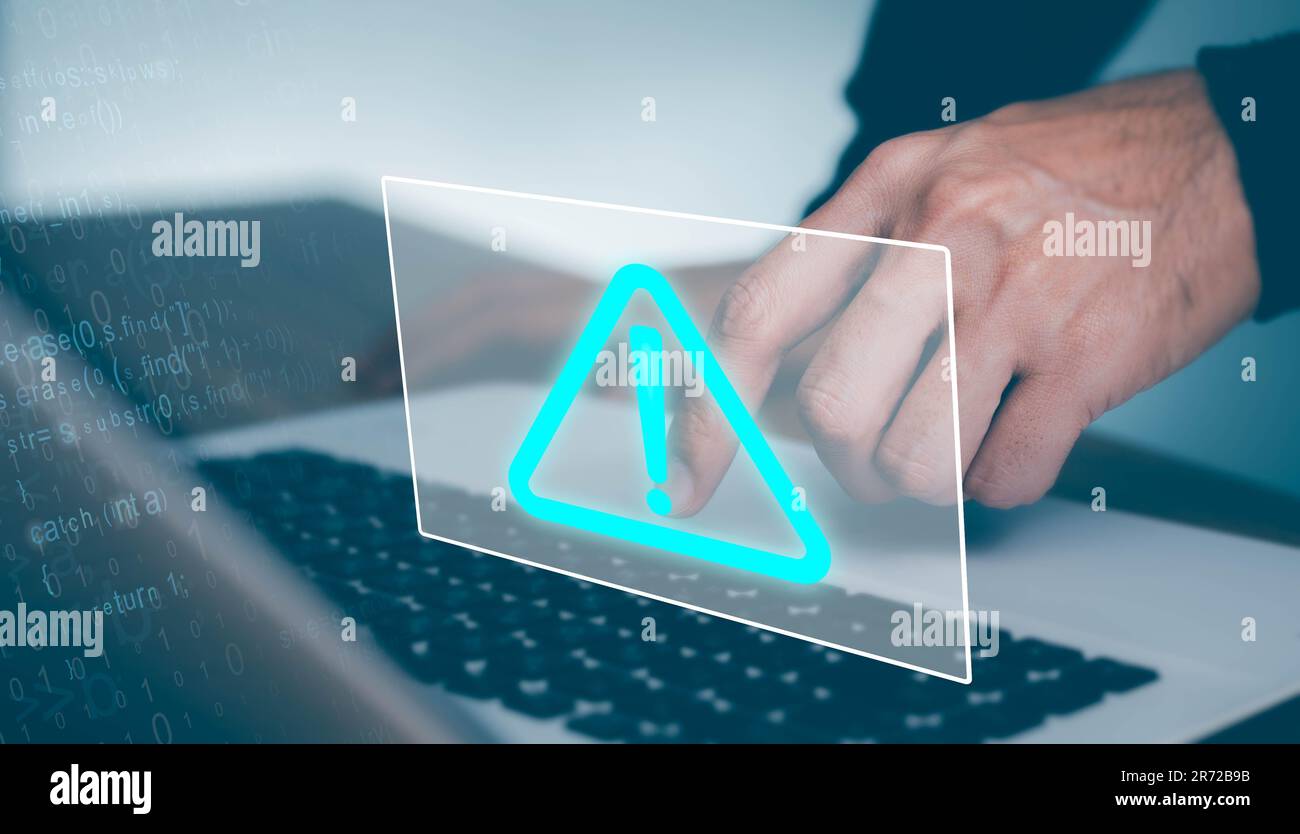 Businessman working on laptop computer at office with exclamation alarm caution warning notification mark Sign, computer virus detected Stock Photo