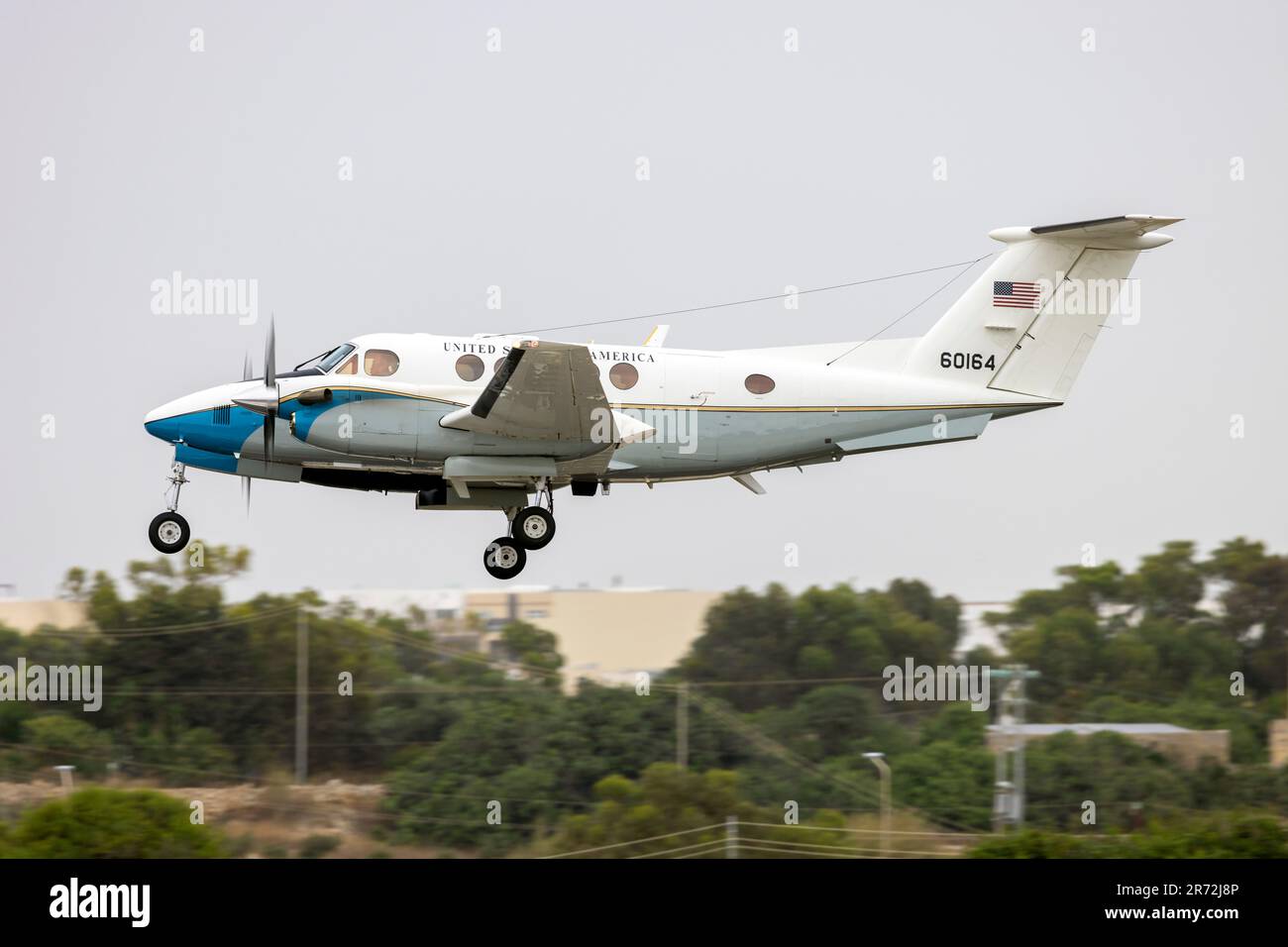 US Air Force (USAF) Beechcraft C-12C Huron (Reg: 76-0164) on finals runway 31 on a cloudy afternoon. Stock Photo