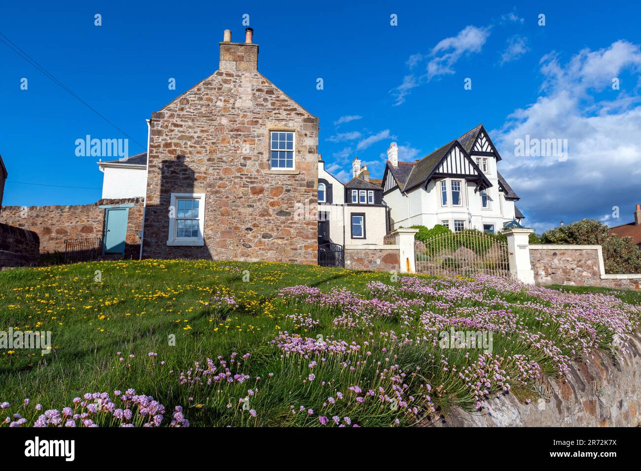 Stoned houses with blossom lawns in The Toft street, Elie and