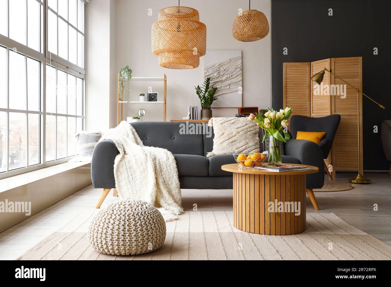 Interior of stylish living room with cozy sofa and coffee table near ...