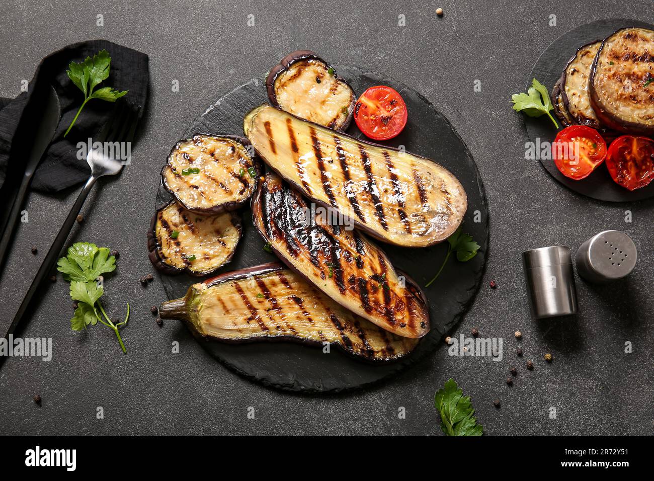 Composition with delicious grilled eggplants on dark background Stock Photo