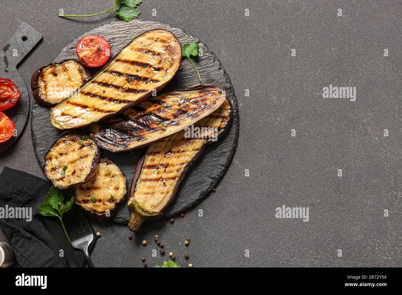 Composition with delicious grilled eggplants on dark background Stock Photo