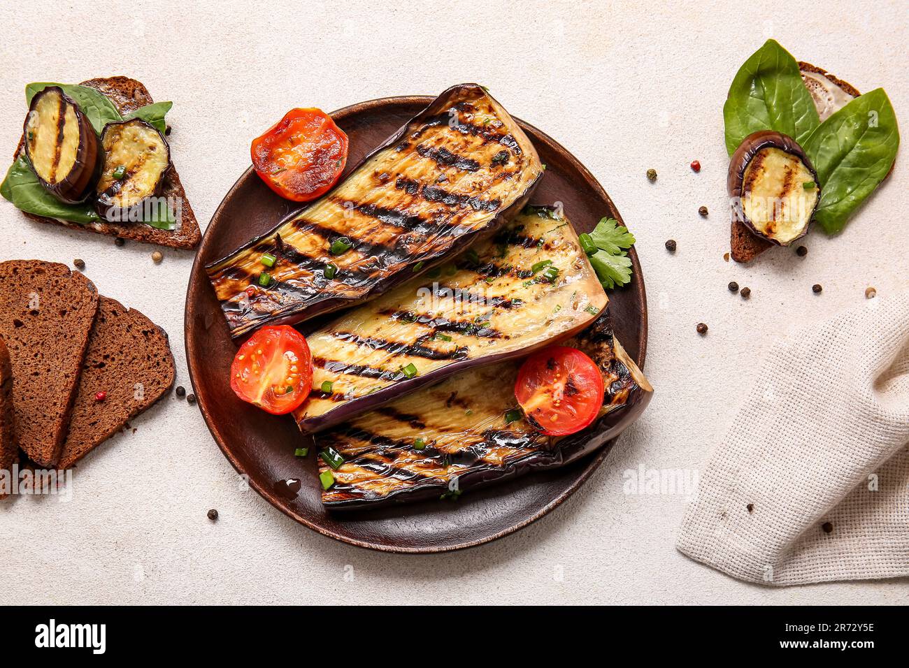 Composition with delicious grilled eggplants on light background Stock Photo