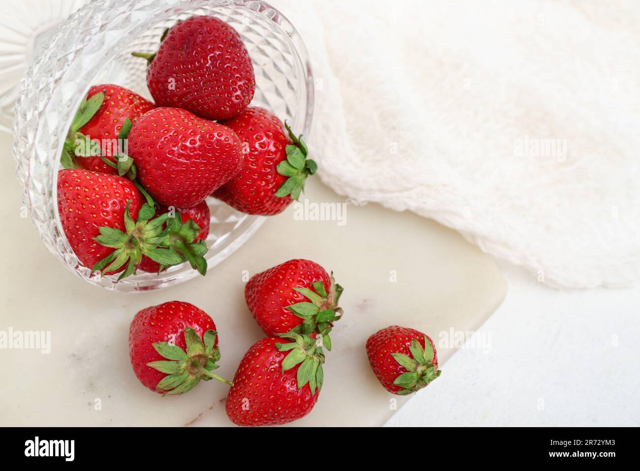 Glass bowl with fresh strawberries on white background Stock Photo - Alamy
