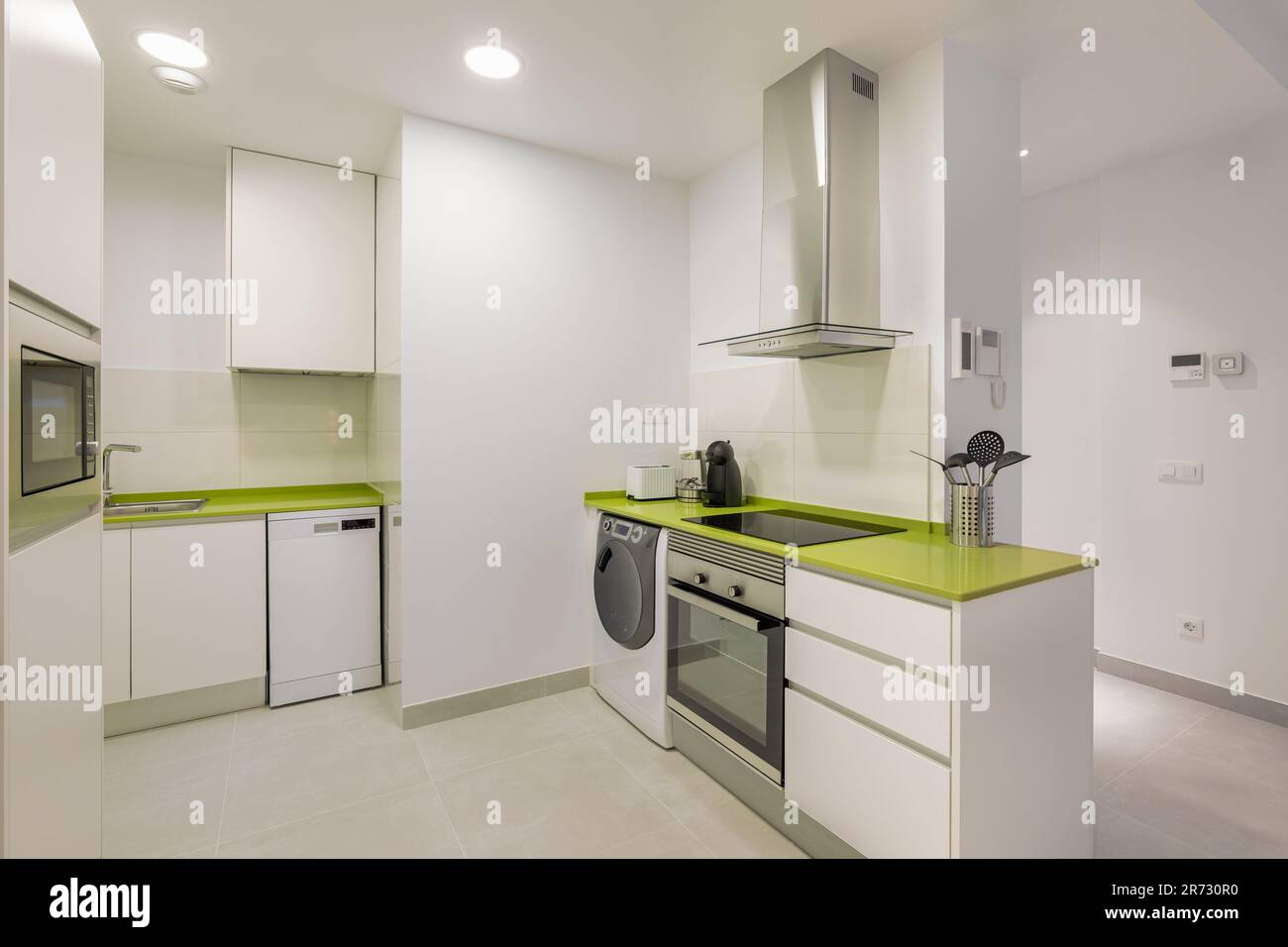 Modern Kitchen with White Walls and Green Accents Stock Photo - Alamy