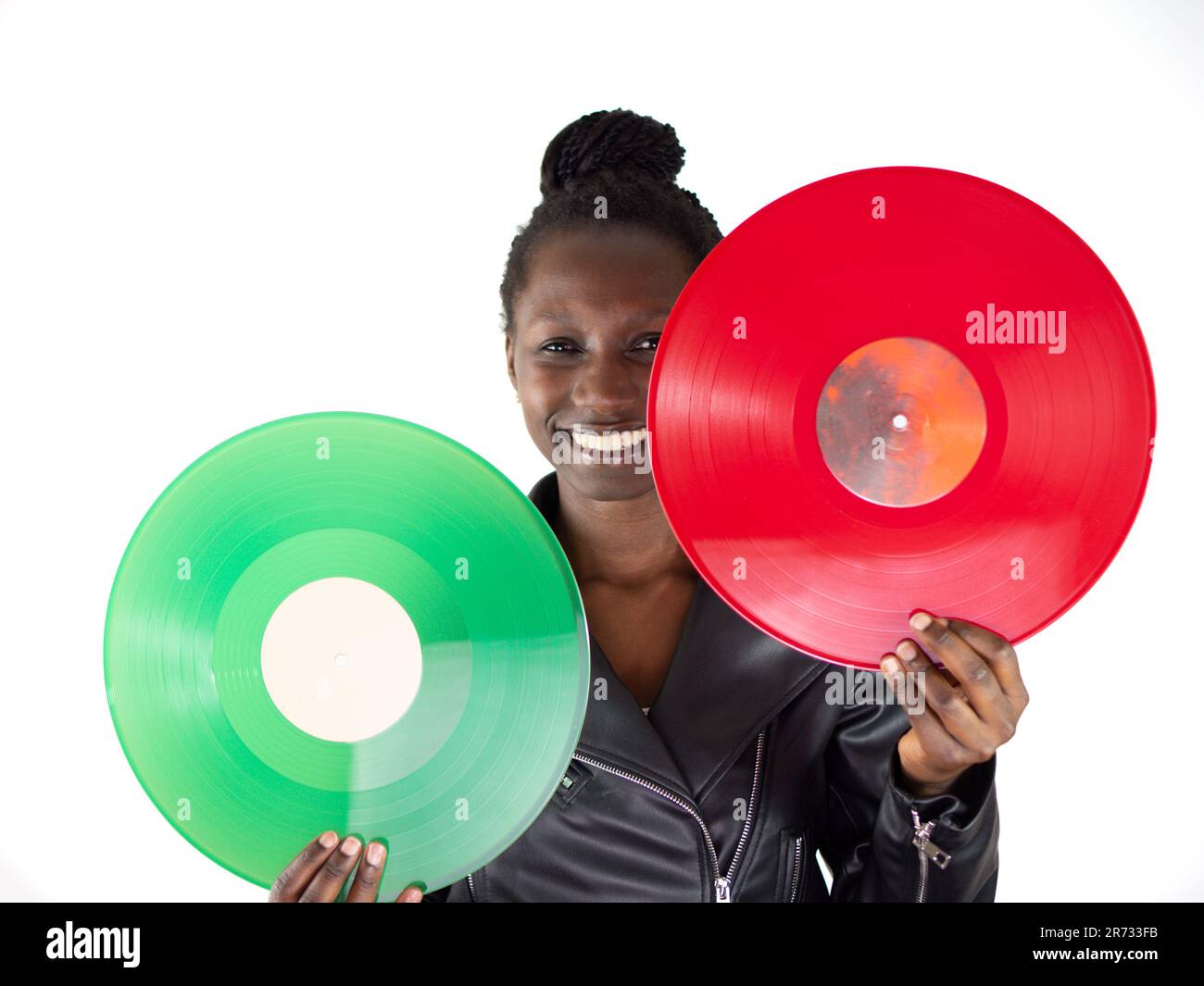 Young woman holding and comparing red and green vinyls on