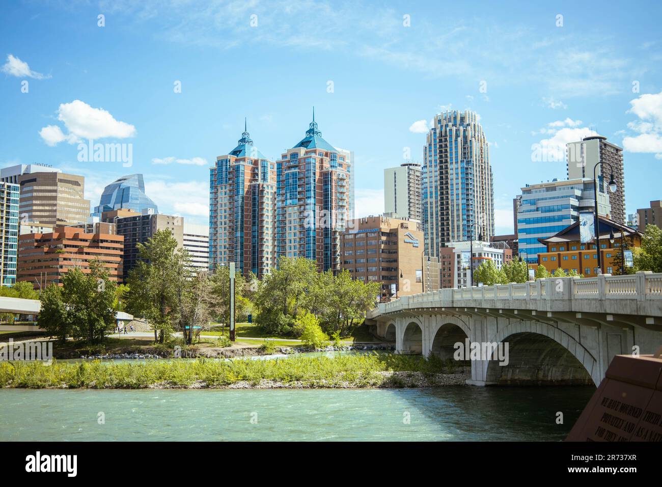 A majestic bridge spanning a tranquil river in a bustling metropolitan cityscape Stock Photo