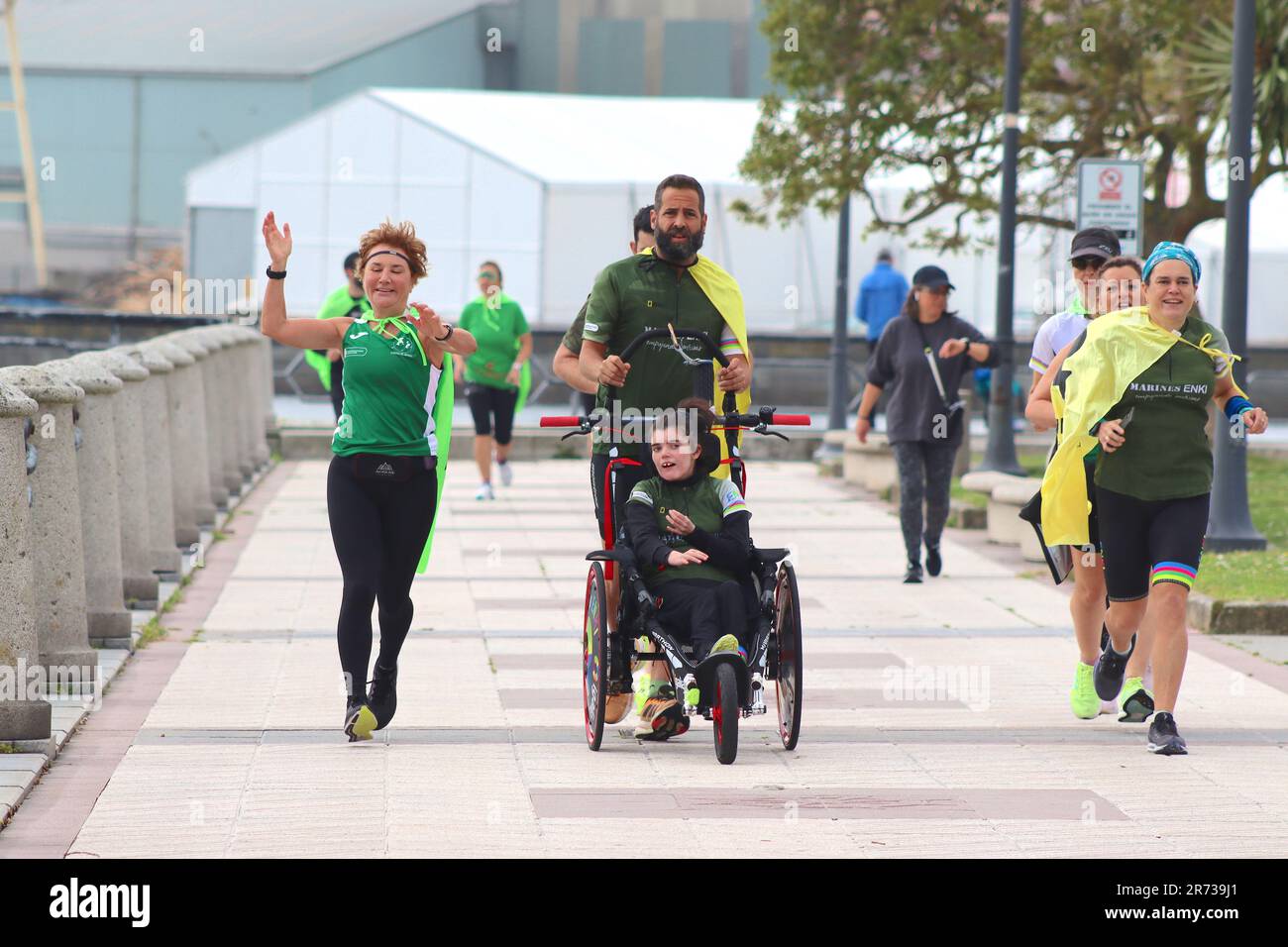 Marines ENKI Charity Run in La Coruna, Spain, highlights awareness of giving disabled children the opportunity to participate with able bodied runners. Stock Photo
