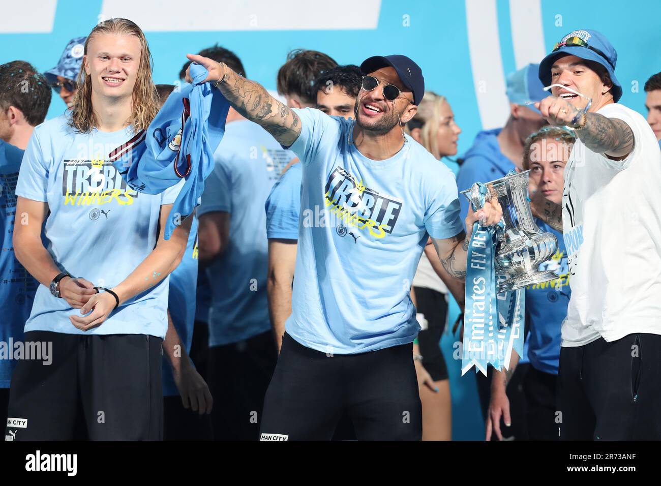 Manchester, UK. 12th June, 2023. Erling Haaland, Kyle Walker and Emerson of Manchester City during the Manchester City's victory parade for European Cup, the FA Cup and the Premier League, in the streets of Manchester, northern England on June 12, 2023  (Photo by Phil Bryan/Alamy Live News) Credit: Philip Bryan/Alamy Live News Stock Photo