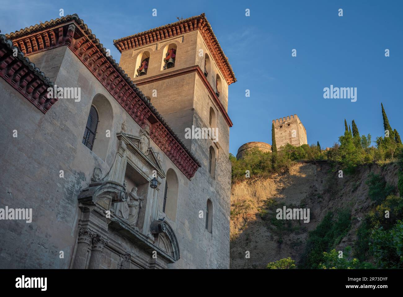 Church of St. Peter and St. Paul  (Iglesia de San Pedro y San Pablo) with Alhambra on background - Granada, Andalusia, Spain Stock Photo
