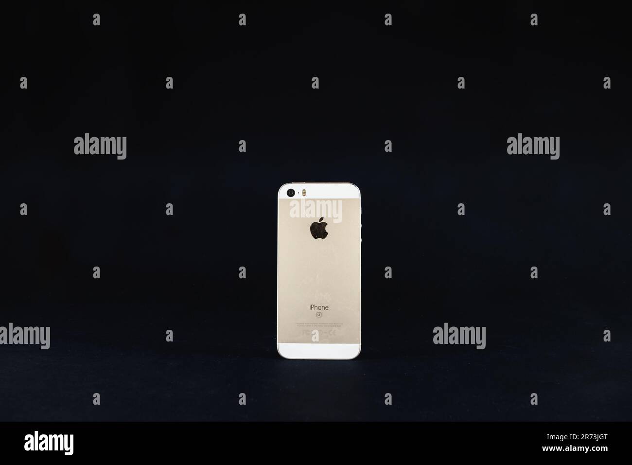 Picture of an Apple Iphone SE first generation on a black background. The iPhone SE is a smartphone designed and marketed by Apple Inc. as part of the Stock Photo
