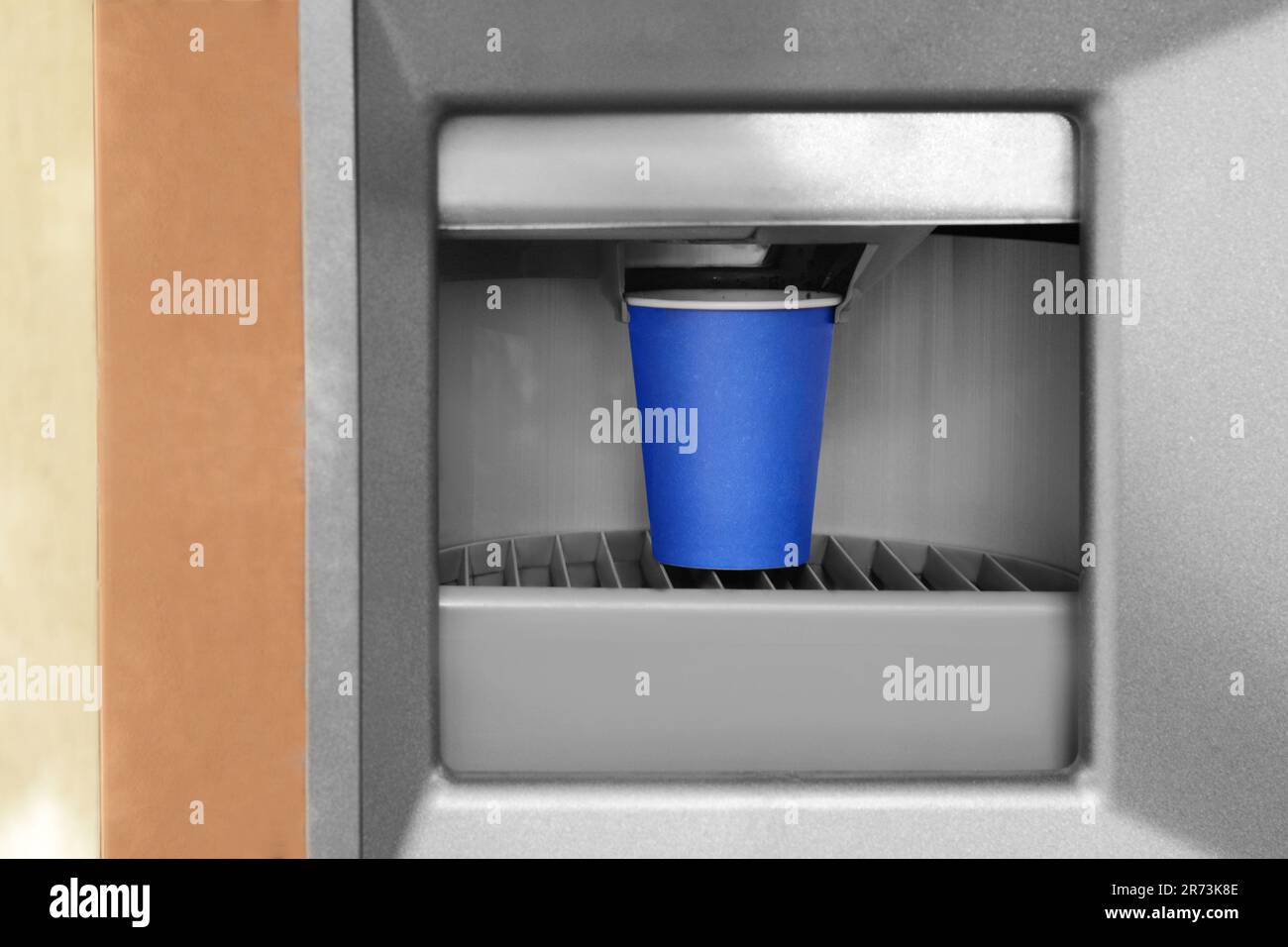 Blue paper cup with coffee in vending machine Stock Photo - Alamy