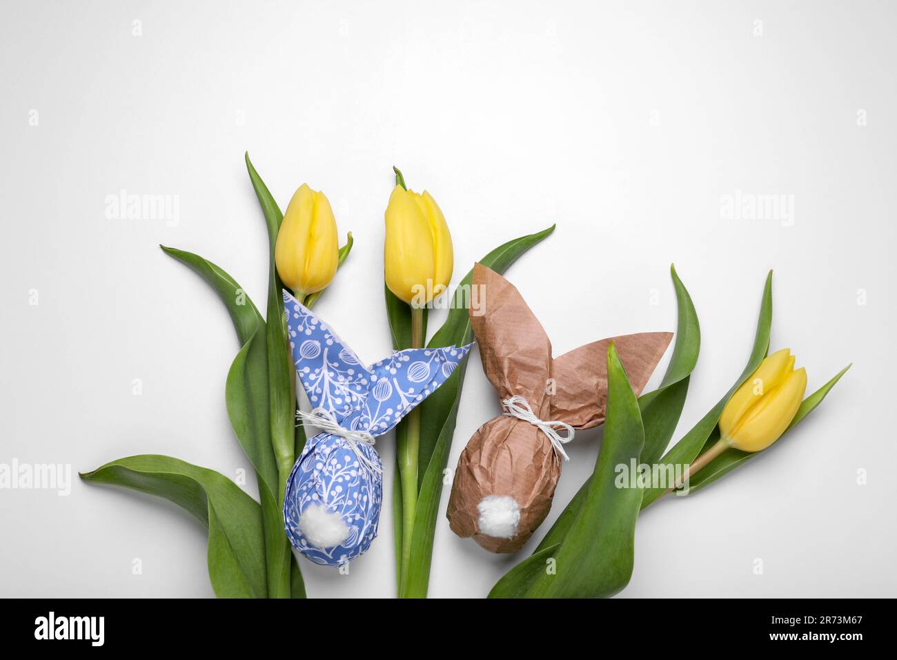 Flat lay composition with Easter bunnies made of paper and eggs on ...