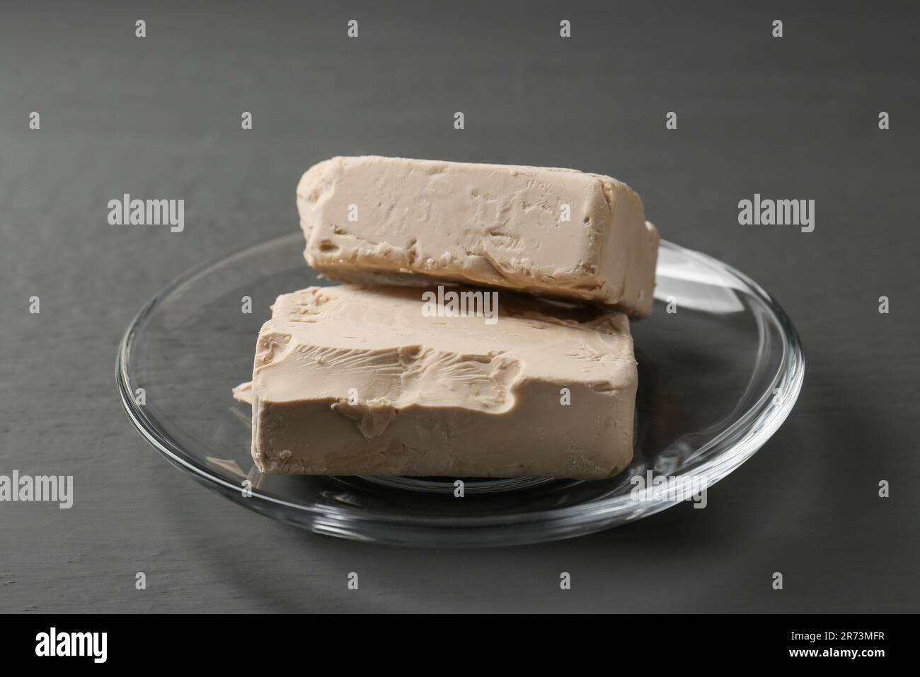 Fresh compressed yeast on grey wooden table Stock Photo