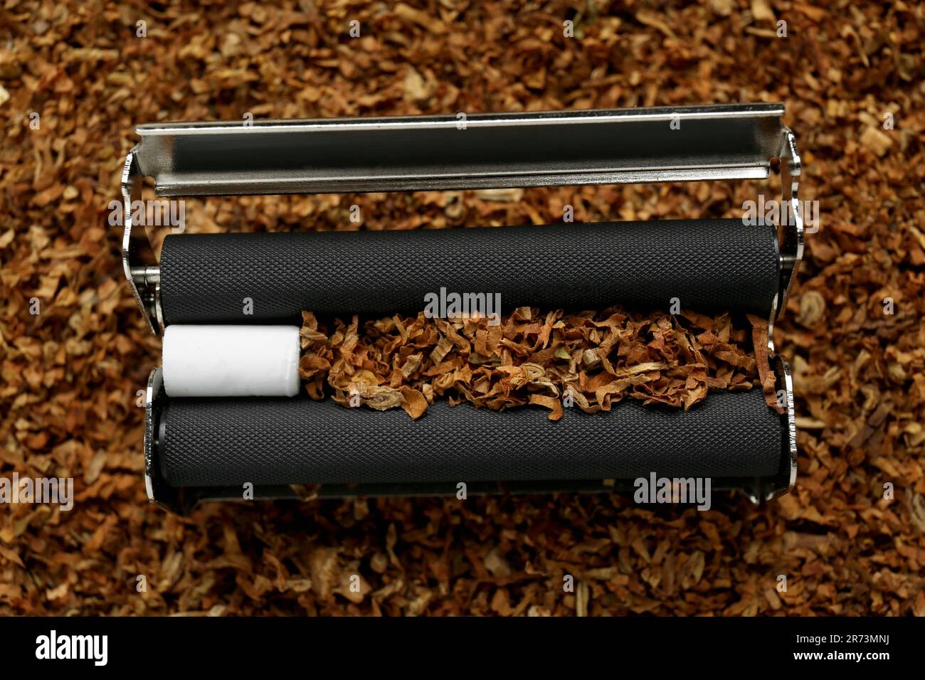Roller with filter and tobacco, closeup view. Making hand rolled cigarette Stock Photo