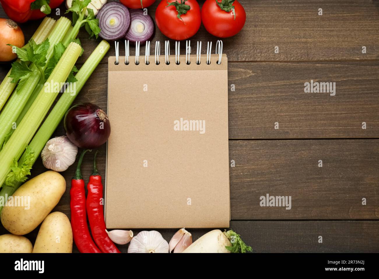 https://c8.alamy.com/comp/2R73N2J/blank-recipe-book-and-different-ingredients-on-wooden-table-flat-lay-space-for-text-2R73N2J.jpg