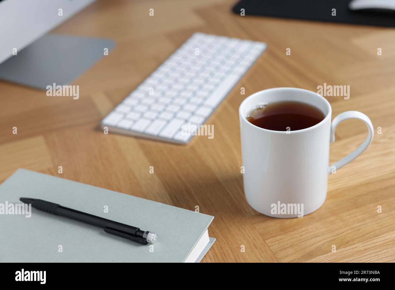 Ceramic mug of tea on wooden table. Mockup for design Stock Photo