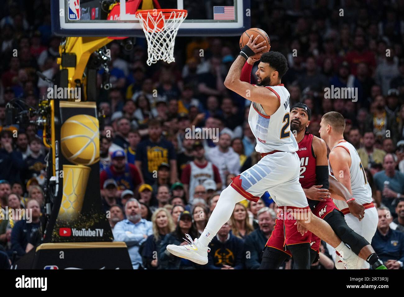 Denver Nuggets guard Jamal Murray, left, looks to pass next to Miami Heat guard Gabe Vincent (2) during the first half of Game 5 of basketballs NBA Finals, Monday, June 12, 2023,