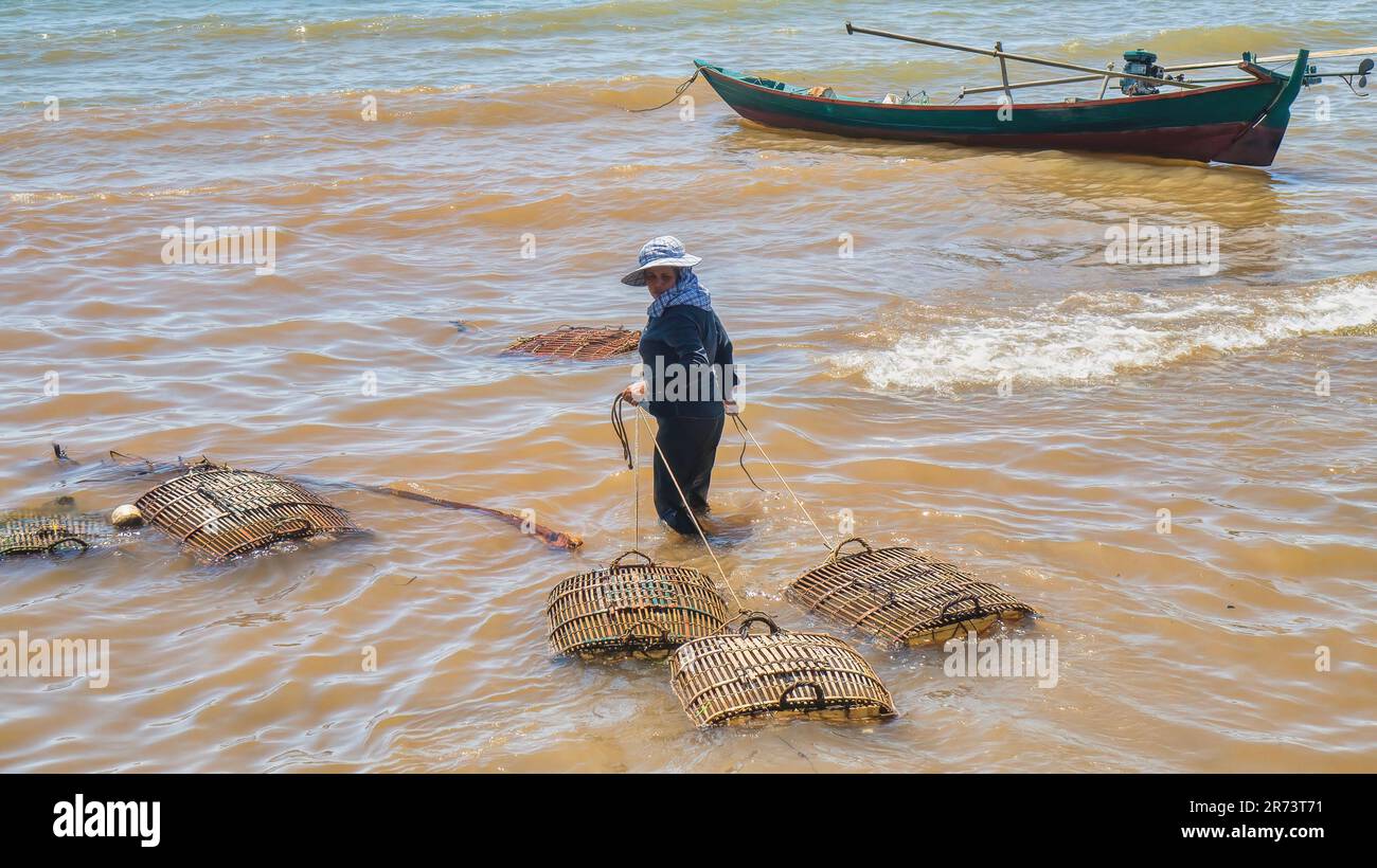 Cylindrical fish trap with ropes drying on the shore near the village at  sunset Stock Photo - Alamy