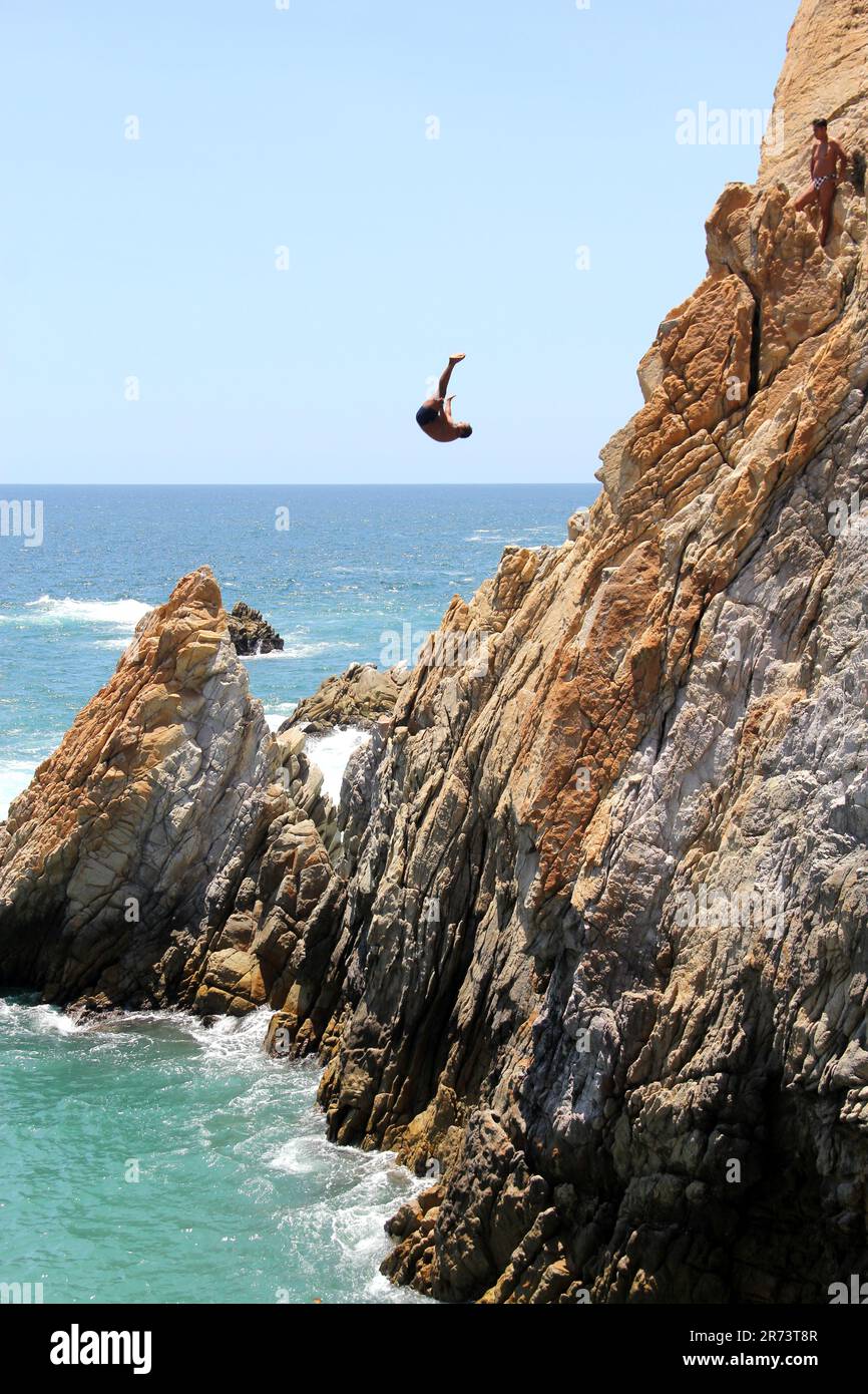 Acapulco, Guerrero, Mexico - Apr 28 2023: Divers of La Quebrada jump from a 45 meter cliff, they are the most popular attraction very old Stock Photo