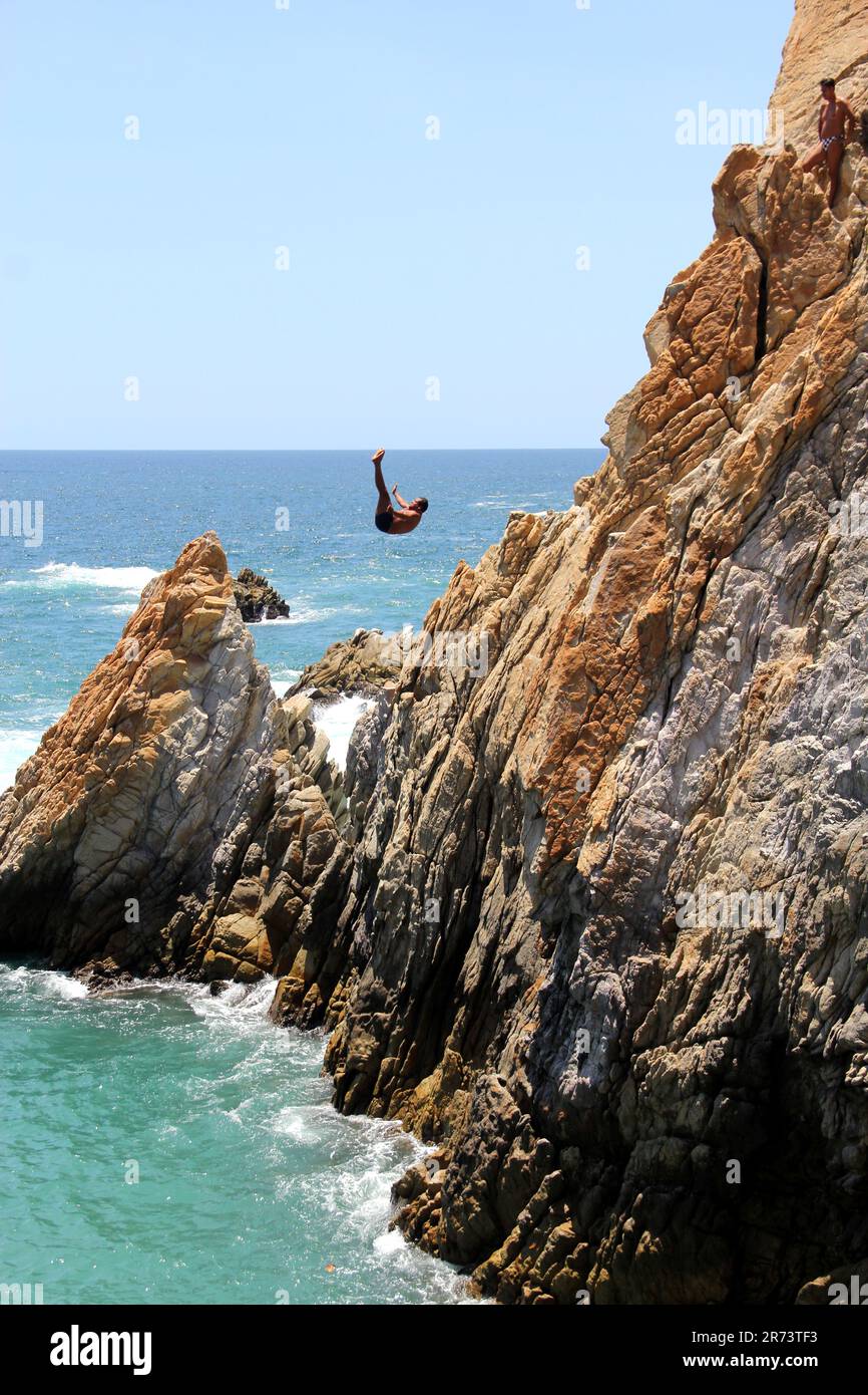 Acapulco, Guerrero, Mexico - Apr 28 2023: Divers of La Quebrada jump from a 45 meter cliff, they are the most popular attraction very old Stock Photo