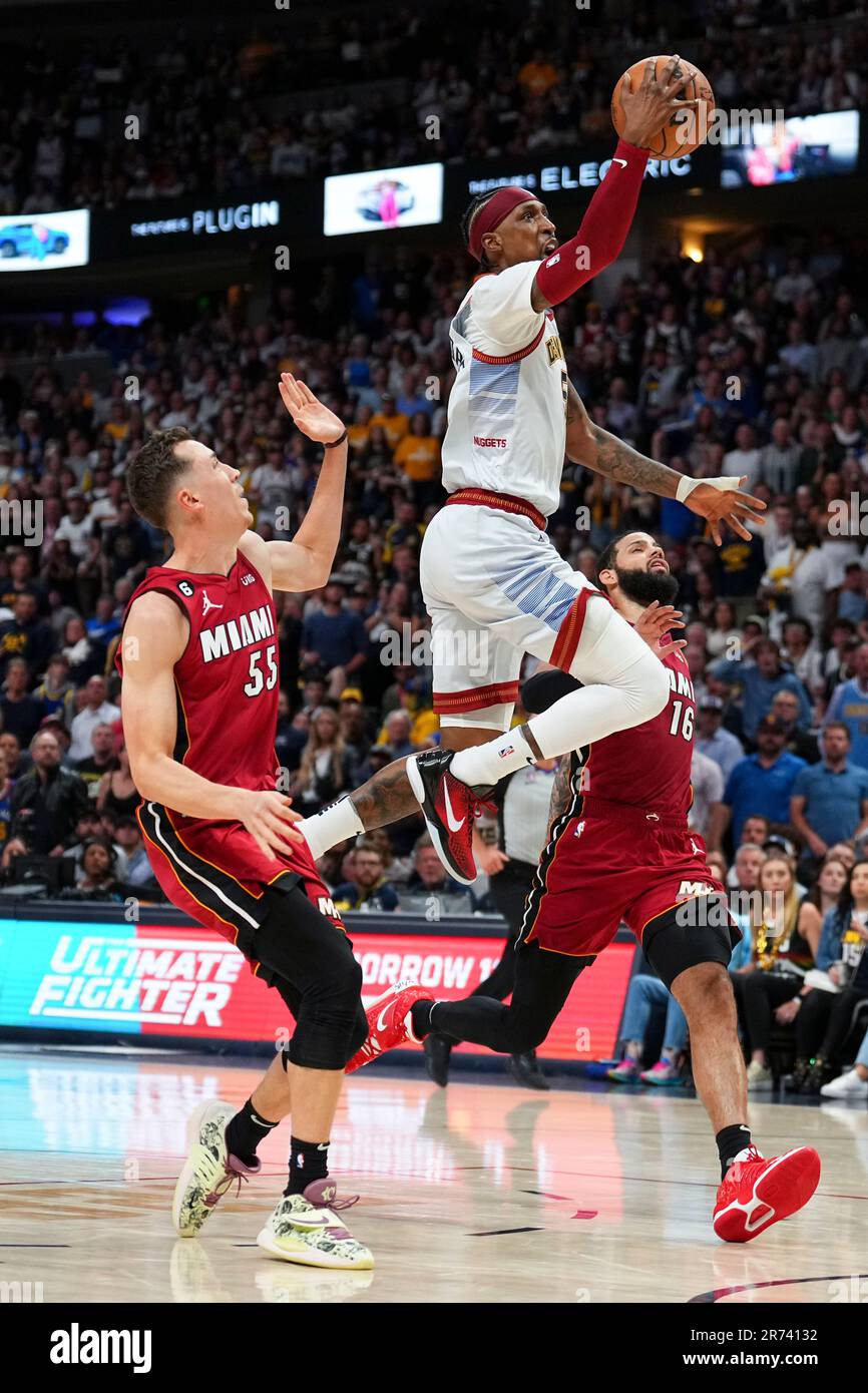 Denver Nuggets guard Kentavious CaldwellPope, center, shoots next to