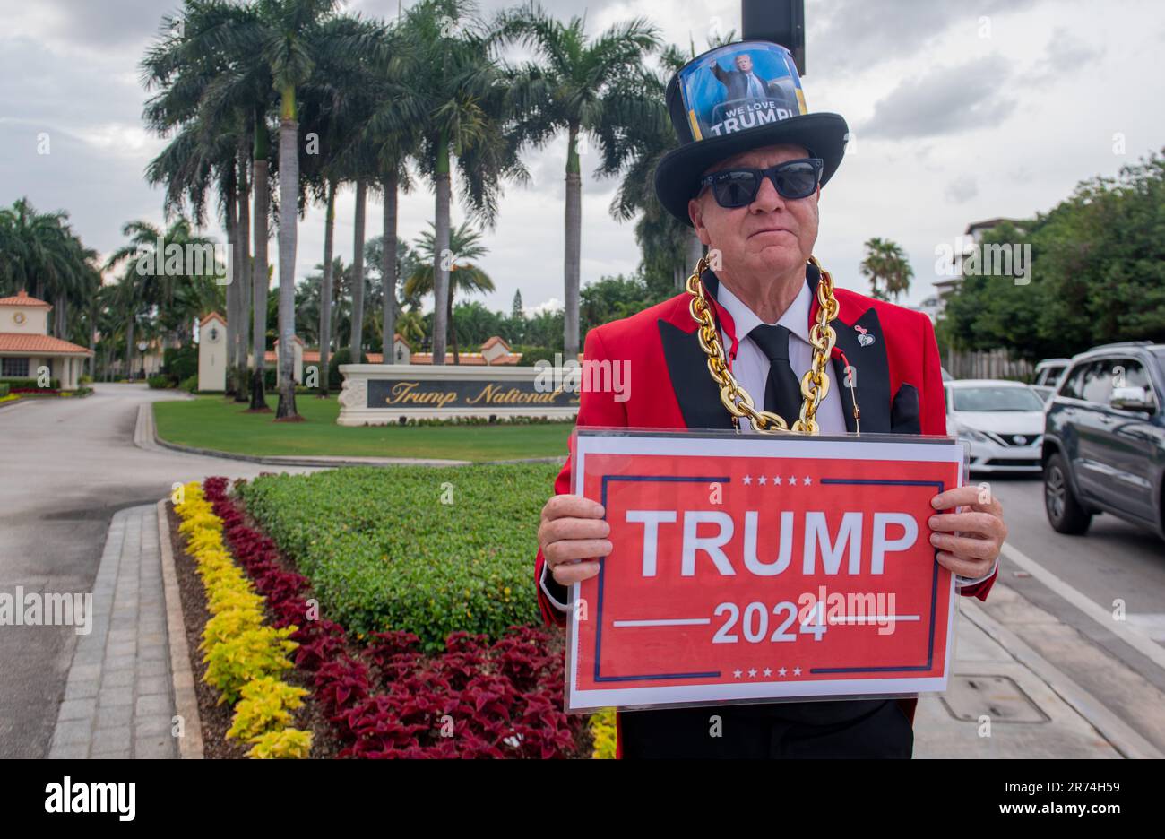 June 12, 2023, Doral, Florida, USA: English Actor GREGG DONOVAN, 64, with Pro-Trump signs, saying TRUMP 2024, the unofficial former 'Ambassador of Hollywood, California', stands in front of the Trump National Doral Golf course. A big Trump supporter, Donovan had just arrived in Miami to protest the indictment of former U.S. President Trump. Gregg was surprised by lack of protesters. To combat the lingering ''Pretty Woman'' motion picture portrayal of Beverly Hills merchants as being snooty and rude and both to help lure shoppers back to the nation's ritziest stores and end an economic slump th Stock Photo